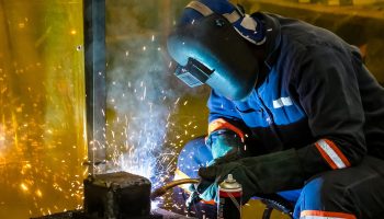 Male working with a welding torch A male working with a welding torch